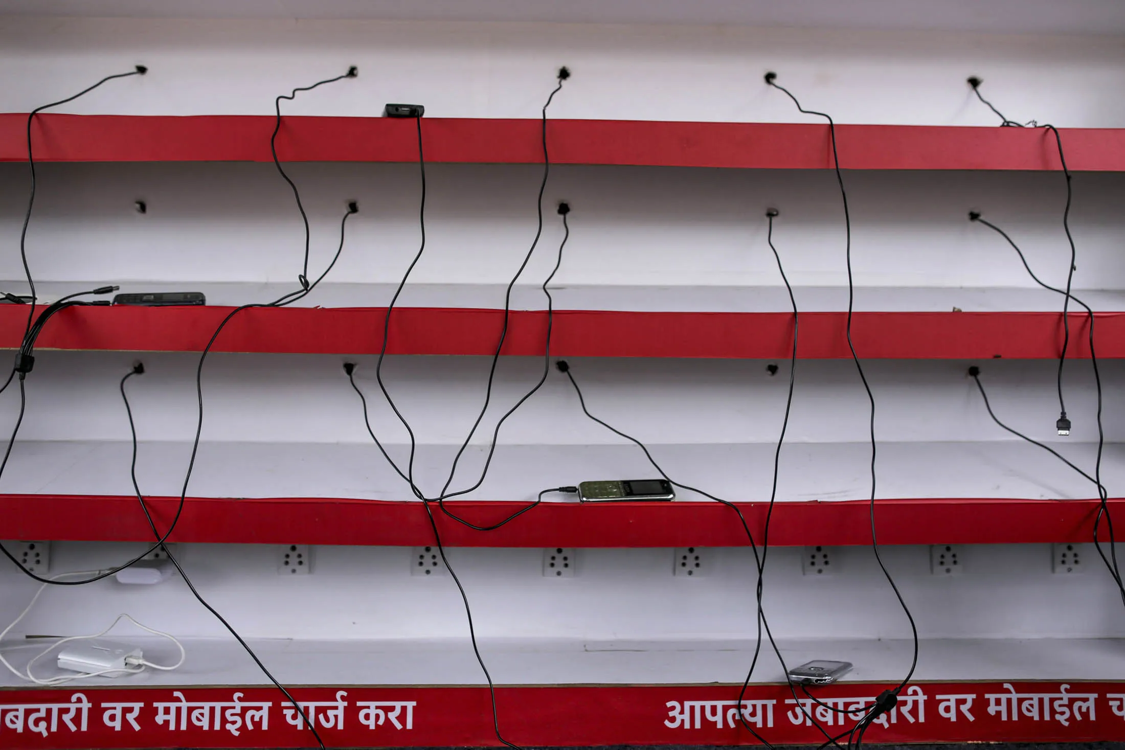 Pilgrims' mobile phones sit at a Vodafone India Ltd. mobile charge station in Nashik, Maharashtra, India, on Saturday, Sept. 12, 2015. Millions of pilgrims in a landscape awash in saffron make their way to the waters of the holy Godavari River for the Kumbh Mela, the festival of the pitcher. It is one of the largest religious festivals on the face of the planet.

