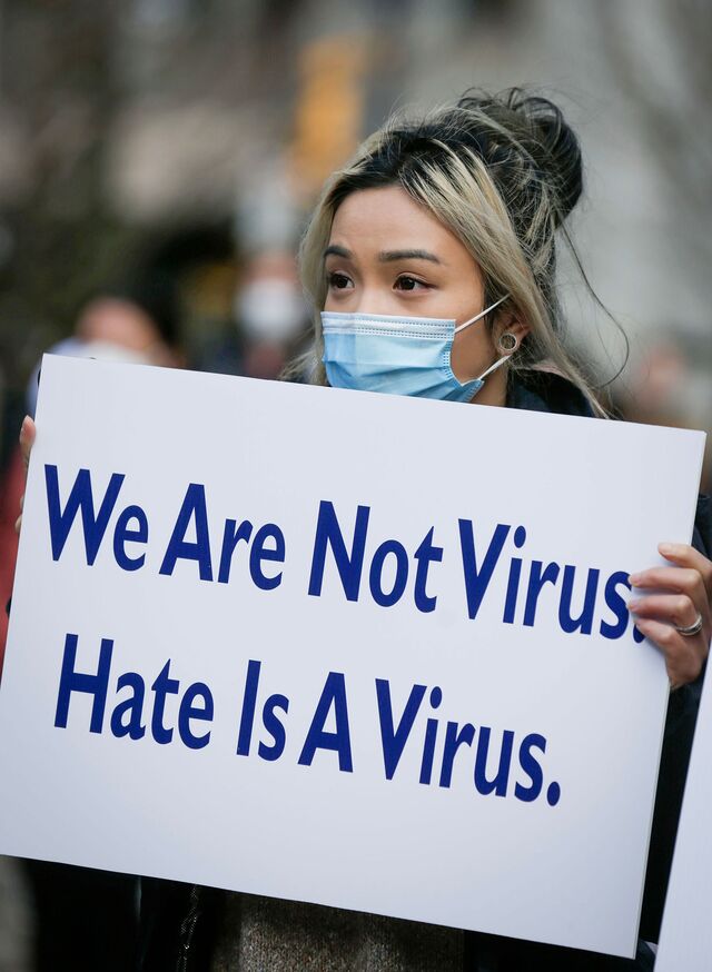 A woman holds a placard during a Stop Asian Hate rally in Vancouver