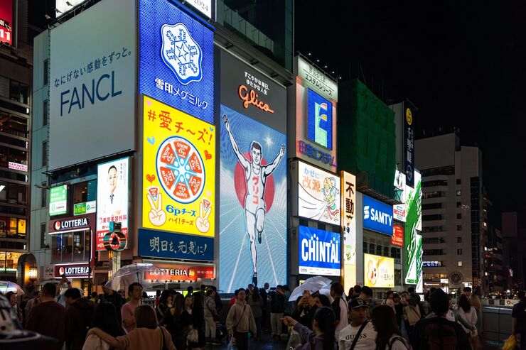 Osaka, Japan - 05.12.2024: The Glico Running Man neon sign in Dotombori district, one of the most popular landmarks in the city.
