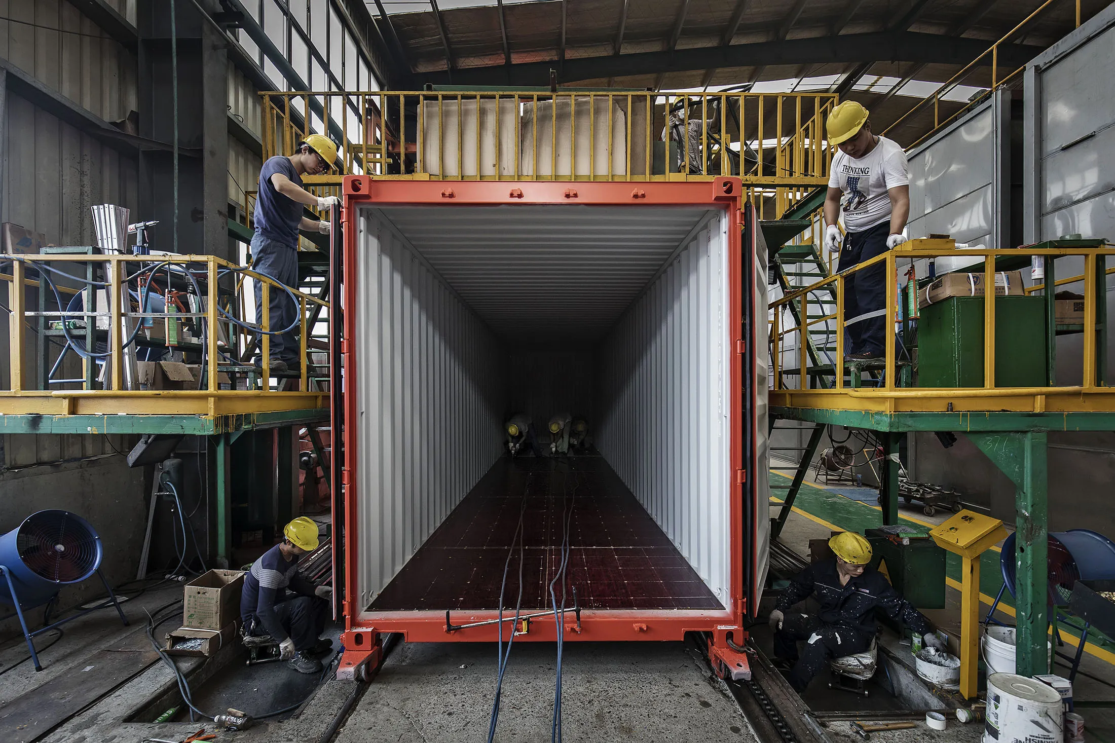 Workers assemble a shipping container at the Singamas Container&nbsp;factory in Qidong, China.
