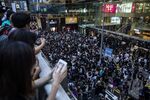 Demonstrators gather in the Tsim Sha Tsui district of Hong Kong on Sunday.