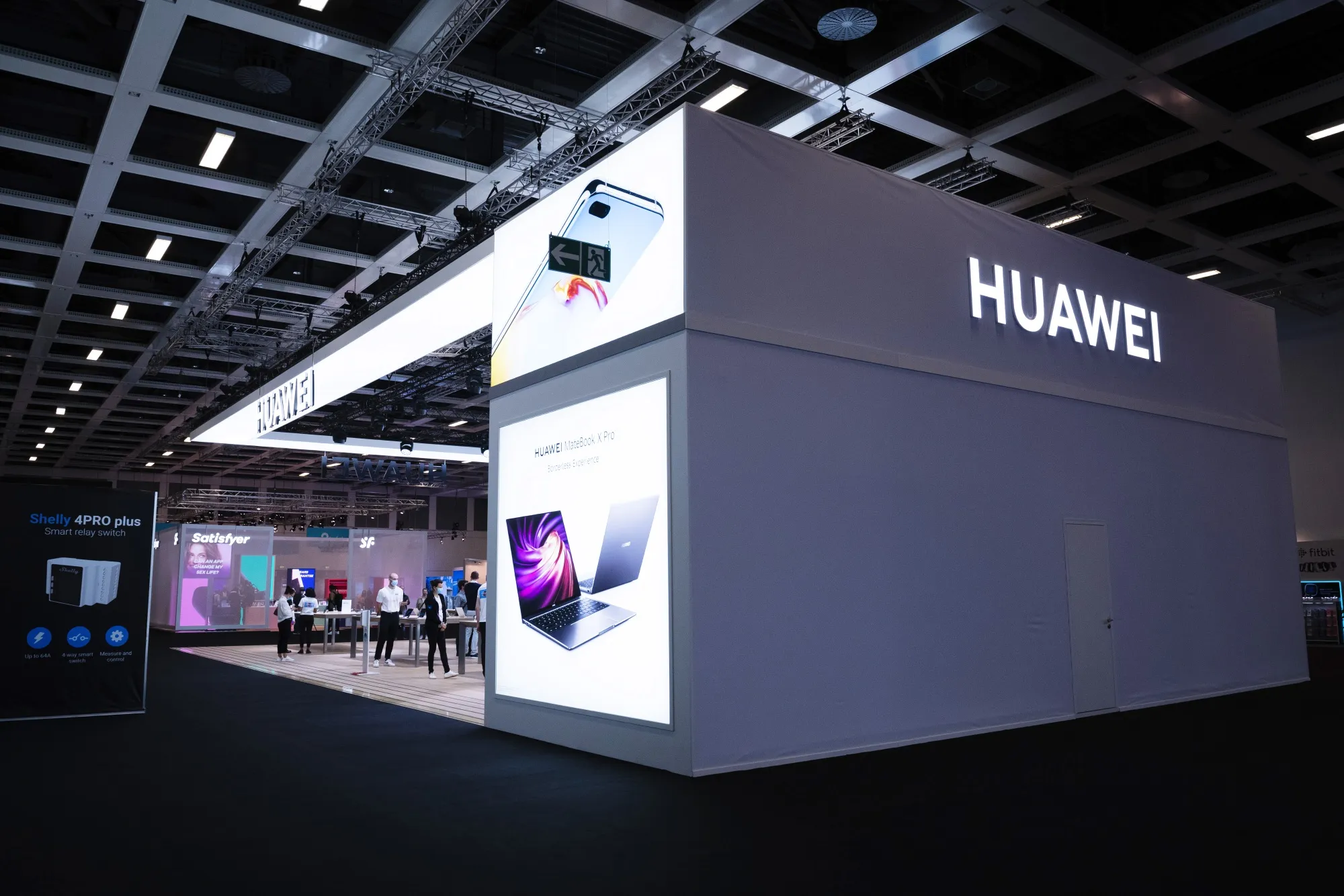 Employees wait for visitors at the Huawei stand during the IFA Consumer Electronics Show in Berlin.