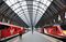 An employee passes between two high speed Virgin trains at Kings Cross station in London, U.K., on Friday, March 18, 2016. Virgin Trains will revive plans to offer high-speed Internet access on EuropeÕs busiest rail route in a bid to beat the plane and persuade business people to travel outside peak hours. Photographer: Chris Ratcliffe/Bloomberg