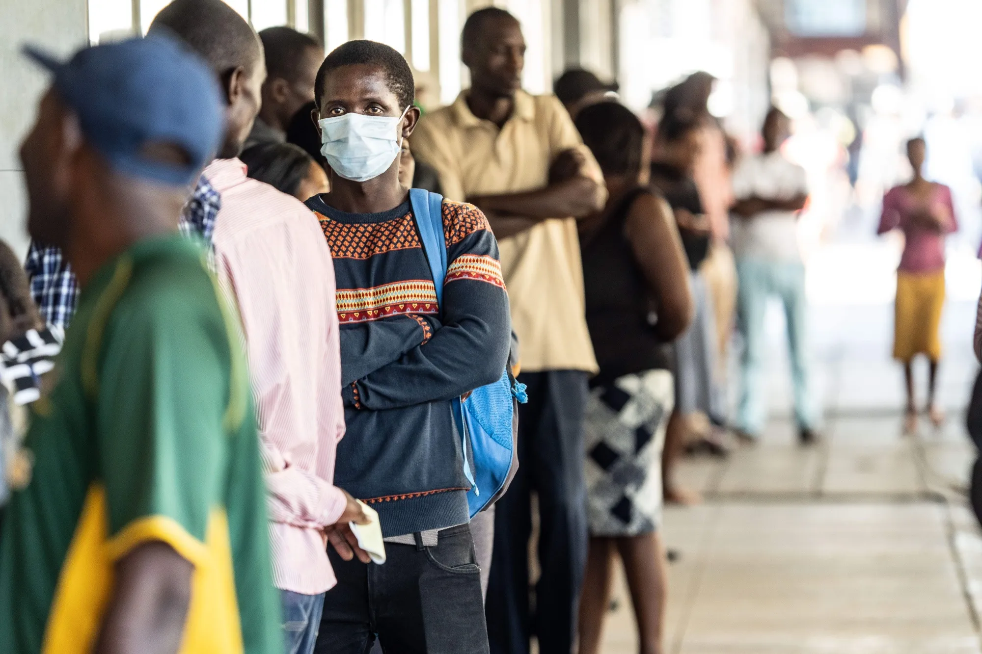 People queue at money transfer service in Bulawayo, Zimbabwe on March 31.