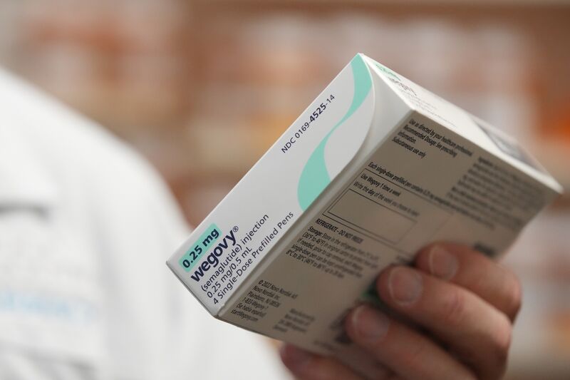A pharmacist holds a box of Novo Nordisk A/S Wegovy brand semaglutide medication arranged at a pharmacy in Provo, Utah, US.