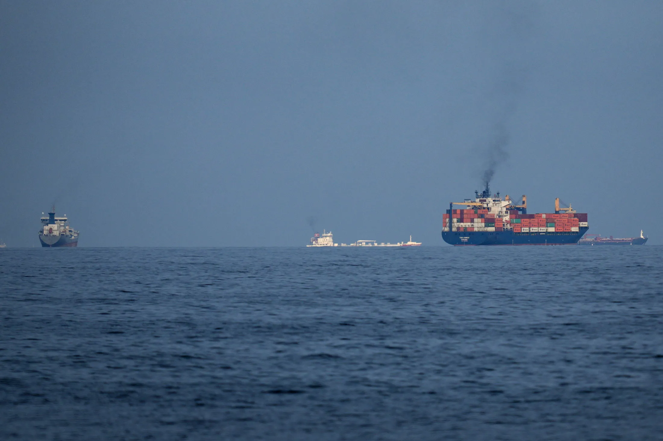 Ships line up in the Strait of Hormuz as seen from Khor Fakkan, UAE in March.