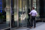 An office worker enters the JPMorgan Chase &amp; Co. headquarters in New York.