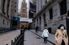 A pedestrian wearing a protective mask walks past the New York Stock Exchange (NYSE) in New York.