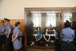 Members of a female punk band 'Pussy Riot' Nadezhda Tolokonnikova, Maria Alyokhina, and Yekaterina Samutsevich, sit inside a glass enclosure during a court hearing in Moscow.