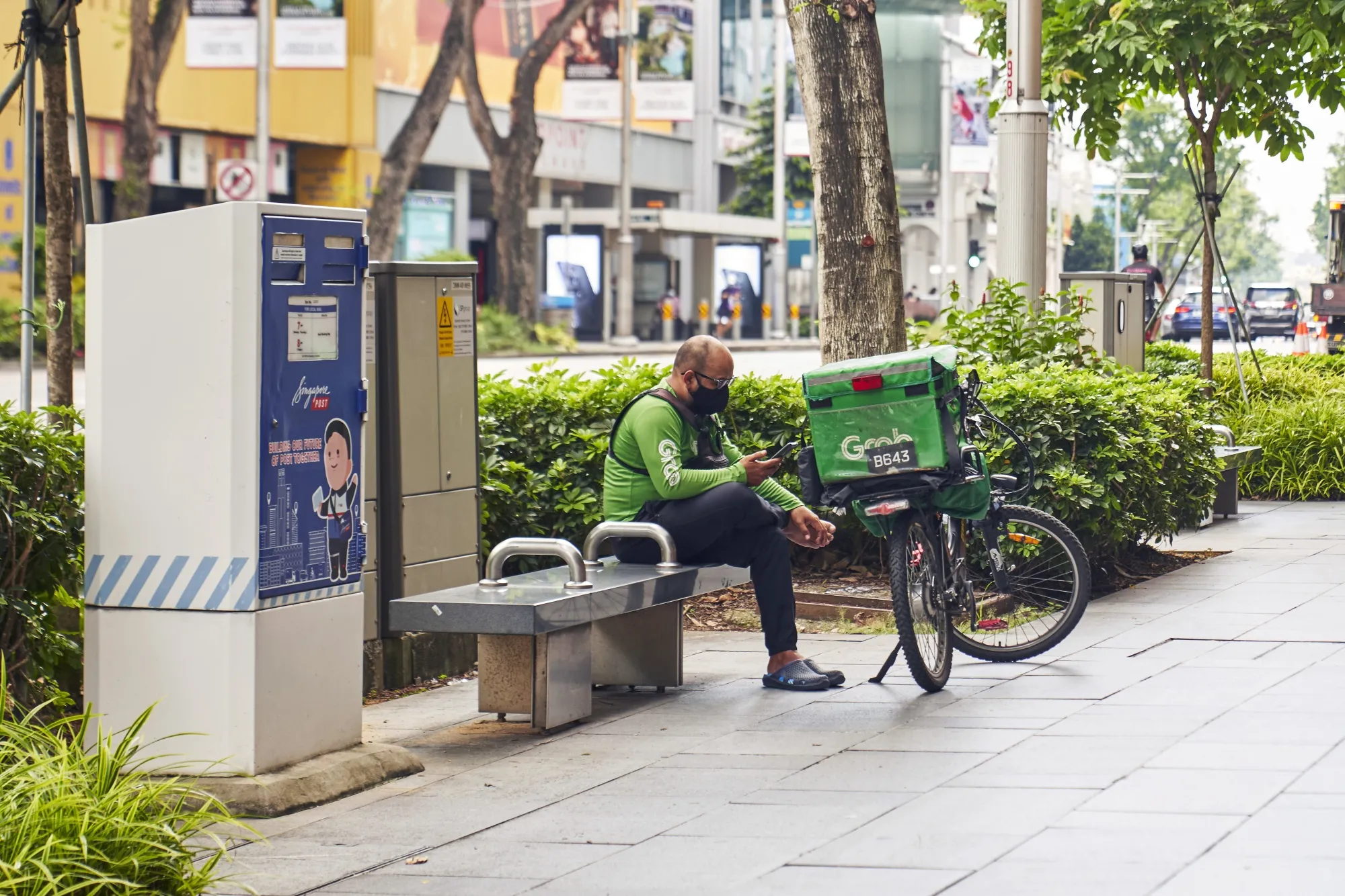 A Grab delivery rider waiting for an order in Singapore, on April 13.