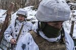 PISKY, UKRAINE - JANUARY 18: Mykola (L) and Viktor, Ukrainian soldiers with the 56th Brigade, in a trench on the front line on January 18, 2022 in Pisky, Ukraine.