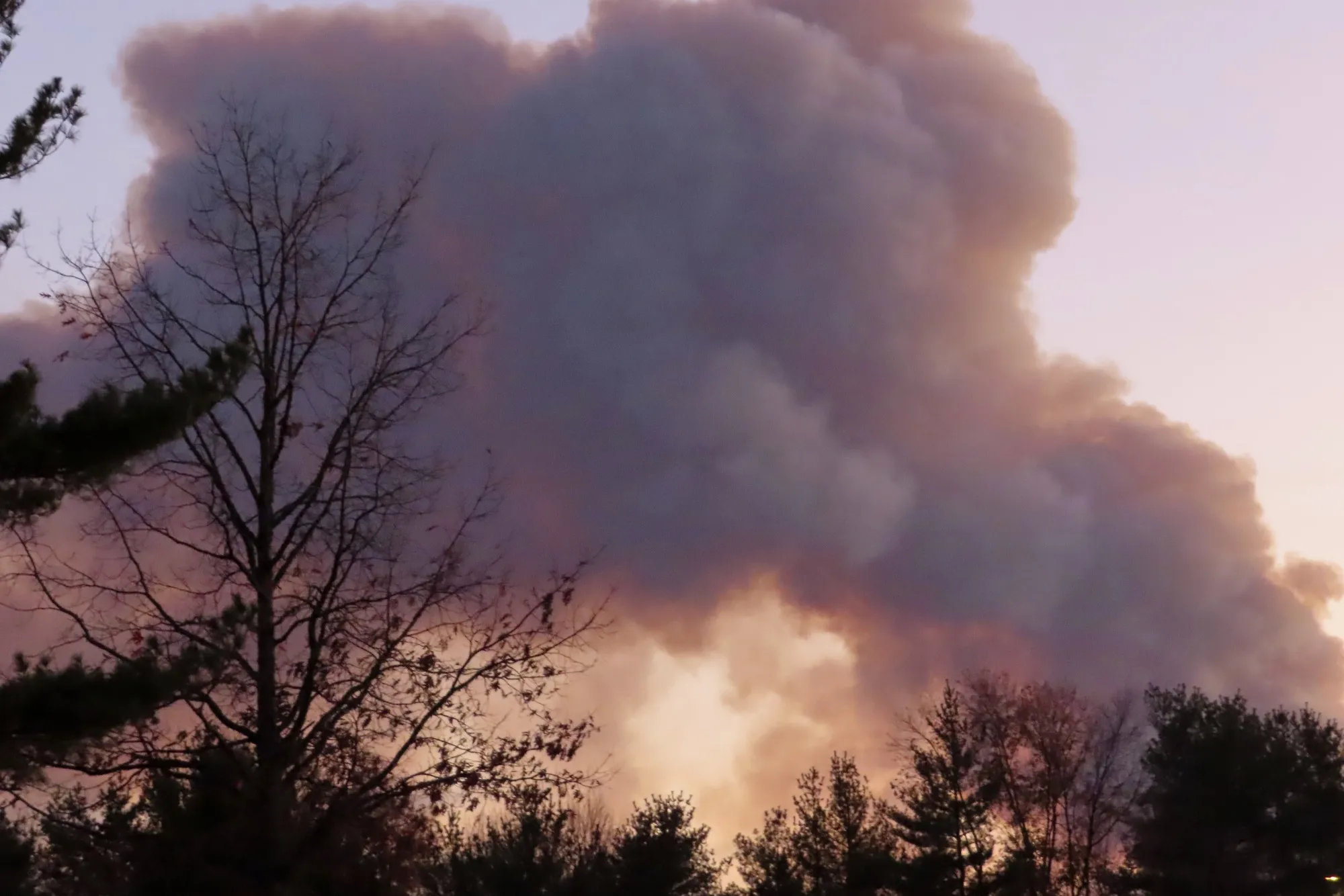 Smoke from a forest fire rises above the trees in Evesham, New Jersey, on Nov. 7.