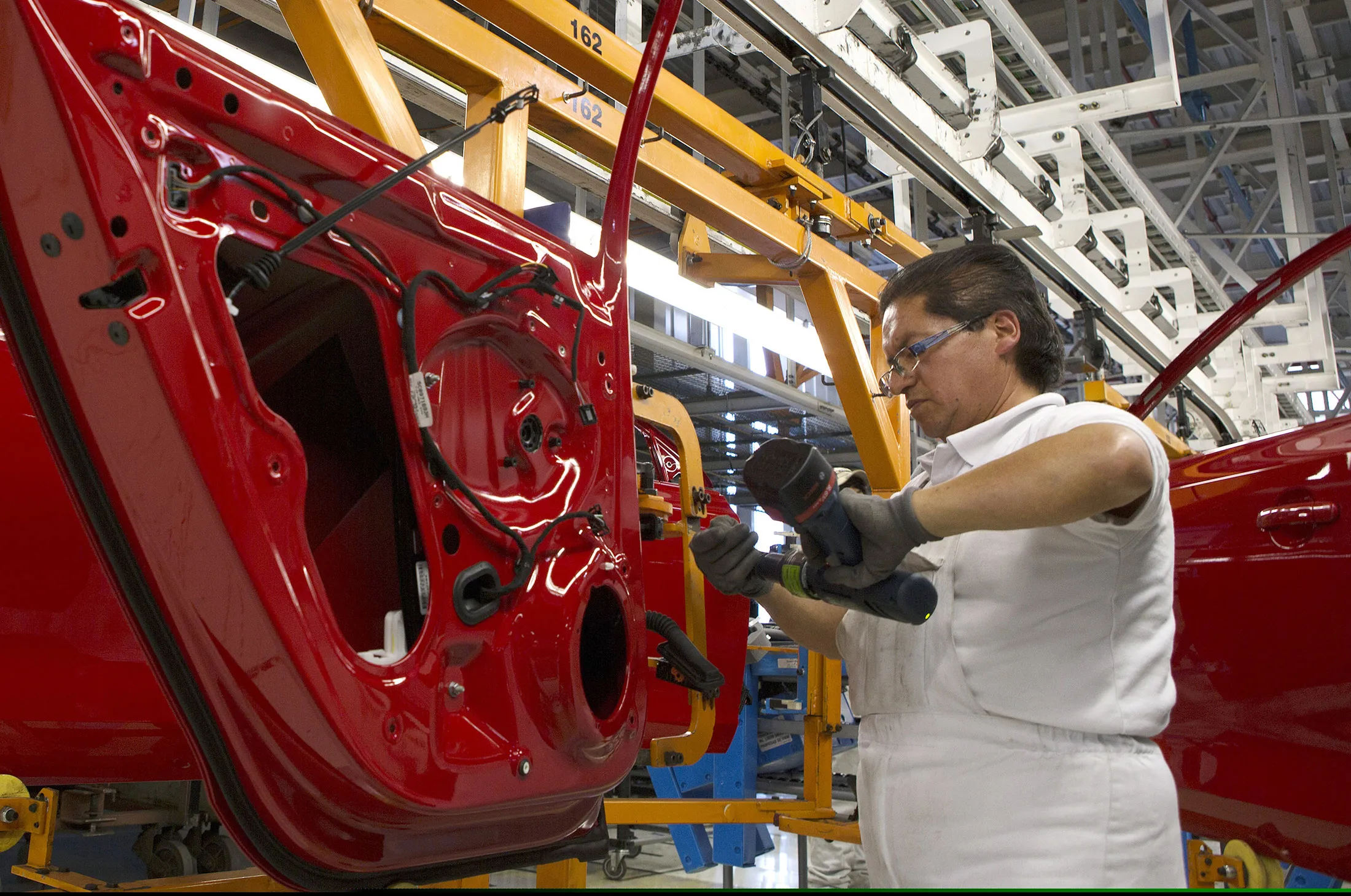 An employee works on the Volkswagen assembly line at their plant in Puebla, Mexico.
