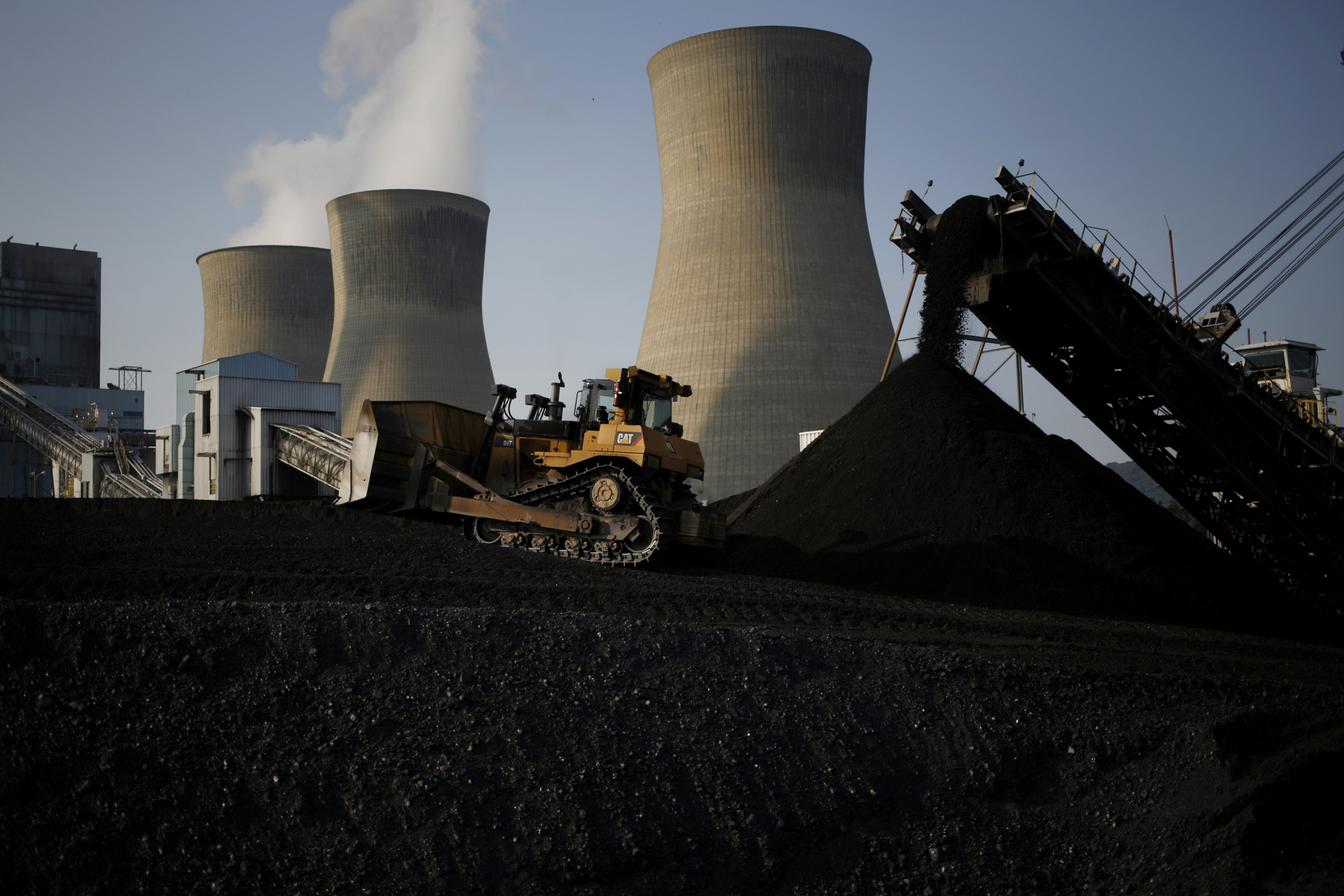 A bulldozer moves coal that will be burned to generate electricity at a&nbsp;power plant in Winfield, West Virginia.