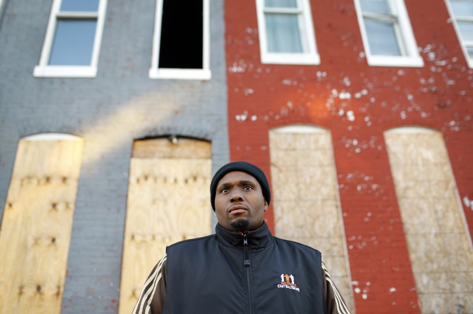 An anti-street violence activist stands in a blighted Baltimore neighborhood.