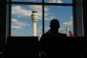 Travelers At Hartsfield–Jackson Atlanta International Airport As Congress Averts FAA Lapse With Stopgap Passage