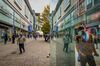 Pedestrians wear protective face masks as they walk past shops on Market Street in Manchester, U.K., on Friday, Oct. 16, 2020.