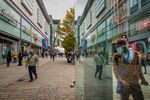 Pedestrians wear protective face masks as they walk past shops on Market Street in Manchester, U.K., on Friday, Oct. 16, 2020.