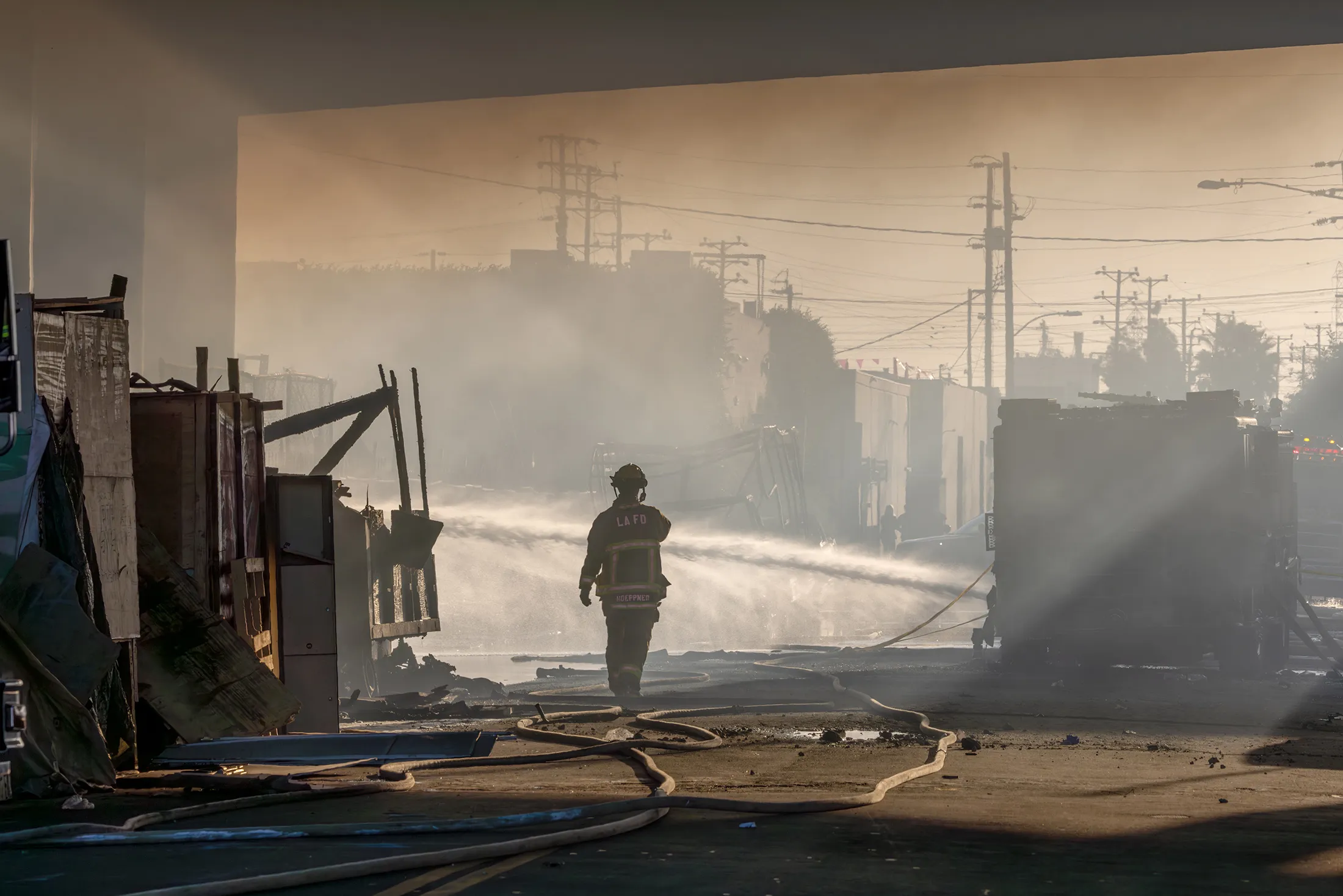 Firefighters douse the still smoldering fire&nbsp;under the I-10 Freeway overpass in Los Angeles, California, on Nov. 11.
