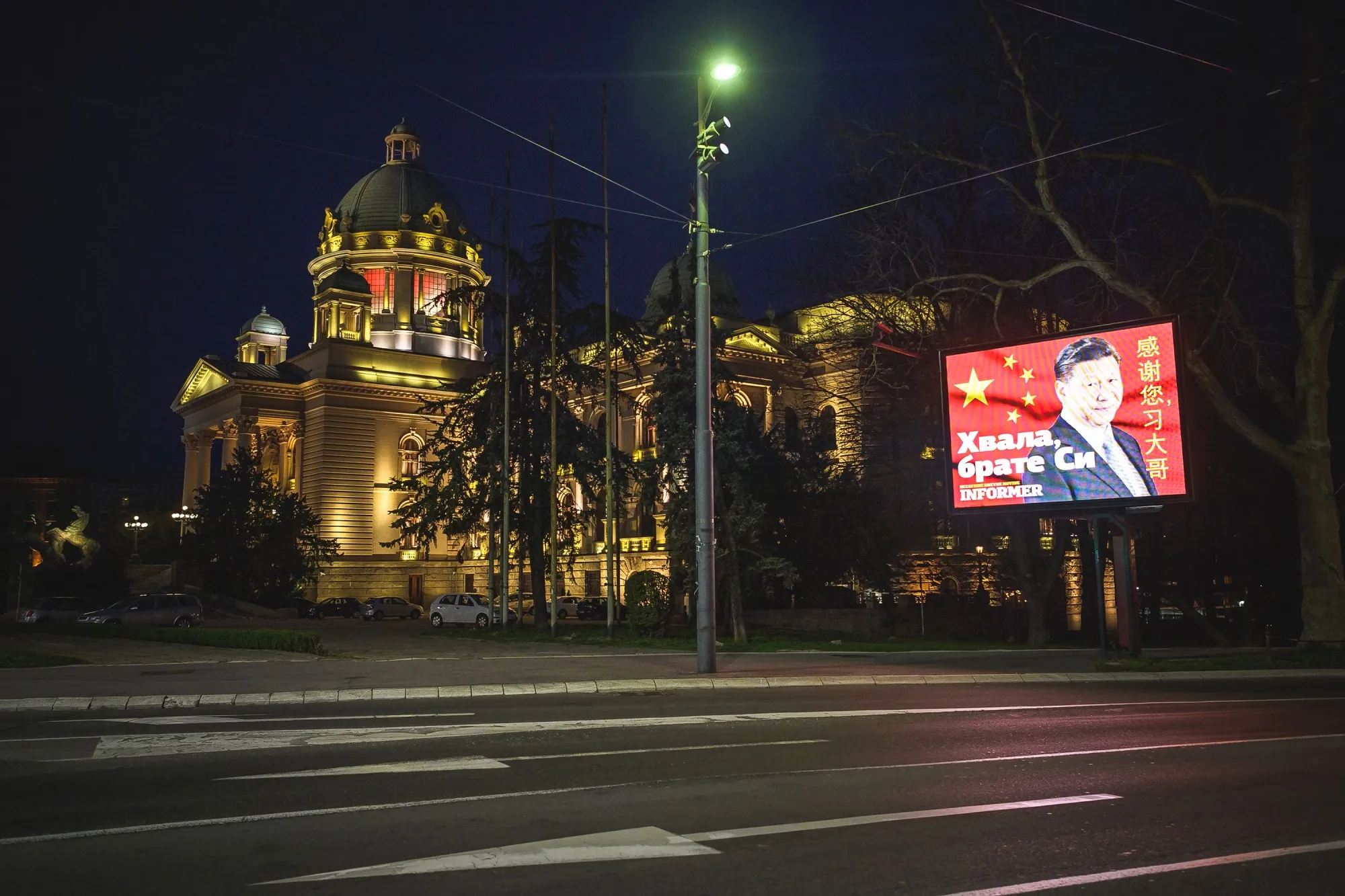 A billboard displays an image of Xi Jinping with the words ‘Thank you brother Xi’ next to the National Assembly building in Belgrade on March 30.
