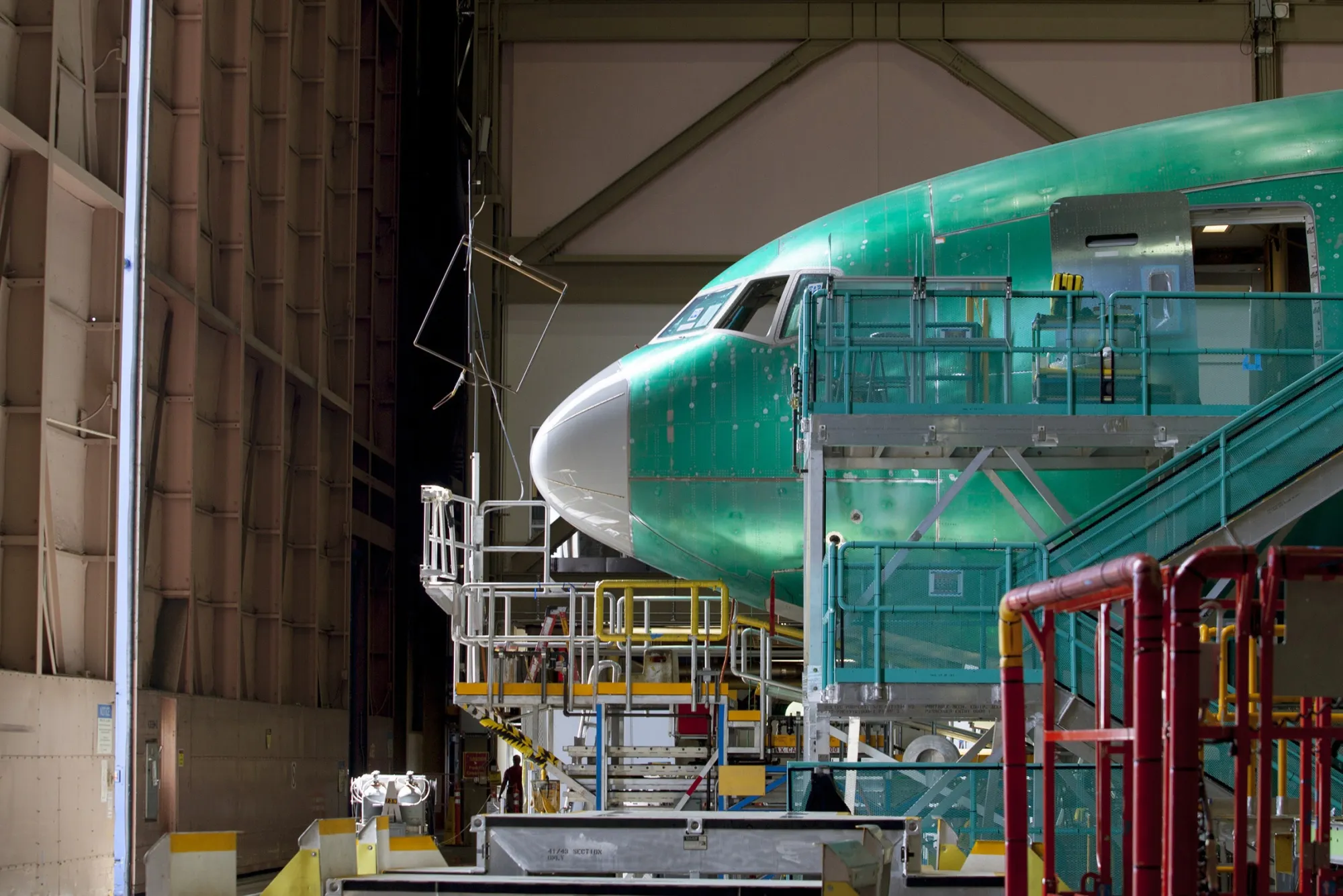 A nearly completed Boeing Co. plane reaches the end of a production line at the company's facility in Everett, Washington.