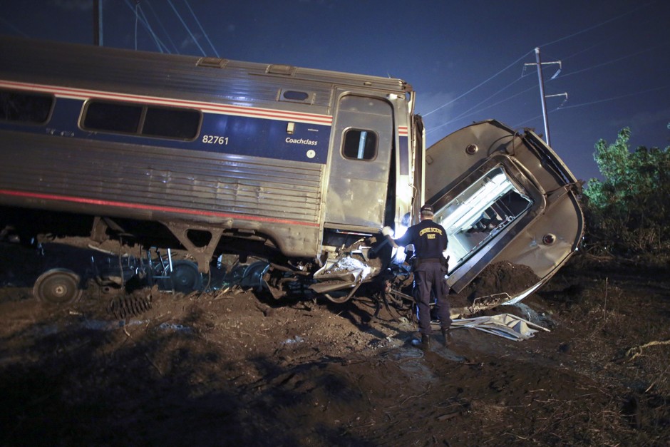 Emergency personnel dig through the wreckage of Amtrak Train 188.