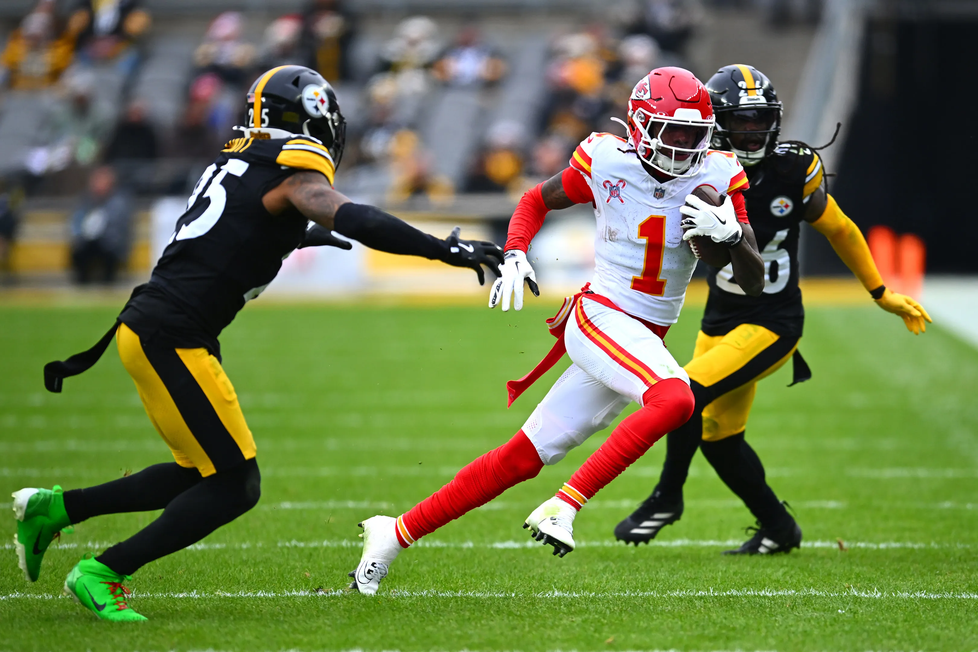 Xavier Worthy #1 of the Kansas City Chiefs is chased by DeShon Elliott #25 of the Pittsburgh Steelers during the fourth quarter at Acrisure Stadium&nbsp;in Pittsburgh on Dec. 25.