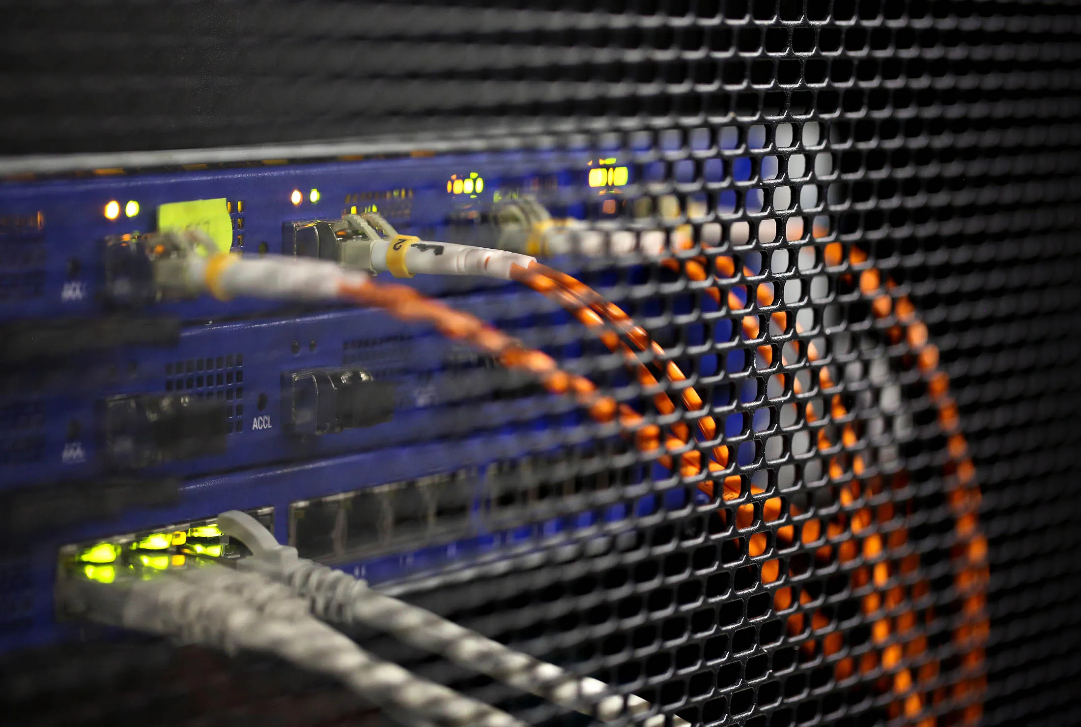 Cables lead from the back of a switch unit in the server hall of the data storage center at the headquarters of Rostelecom PJSC, the state telecommunications operator, in Moscow, Russia, on Tuesday, Dec. 29, 2015. Netflix Inc. signed agreement with Rostelecom to use its TV service starting in 2016.
