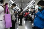 Passengers wearing protective mask ride on a subway train in Beijing.