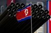 A North Korean flag flies before missiles displayed during a military parade to mark 100 years since the birth of the country's founder Kim Il-Sung in Pyongyang on April 15, 2012. The commemorations came just two days after a satellite launch timed to mark the centenary fizzled out embarrassingly when the rocket apparently exploded within minutes of blastoff and plunged into the sea. AFP PHOTO / Ed Jones (Photo credit should read Ed Jones/AFP/Getty Images)