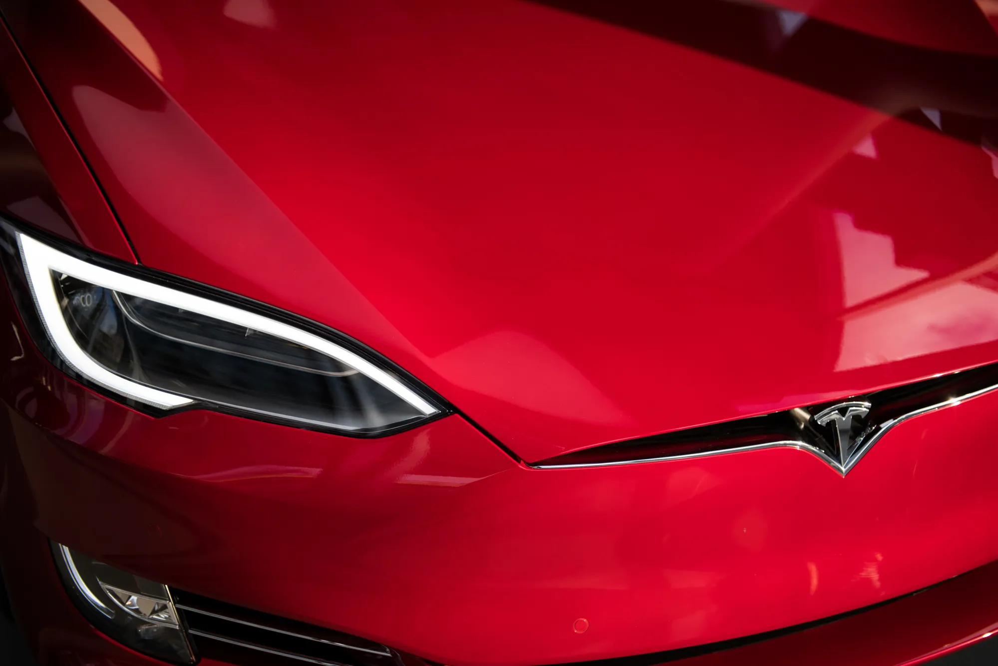 The headlight of a Tesla Inc. Model S P100D sedan vehicle is seen at the company's new showroom in New York, U.S., on Thursday, Dec. 14, 2017.