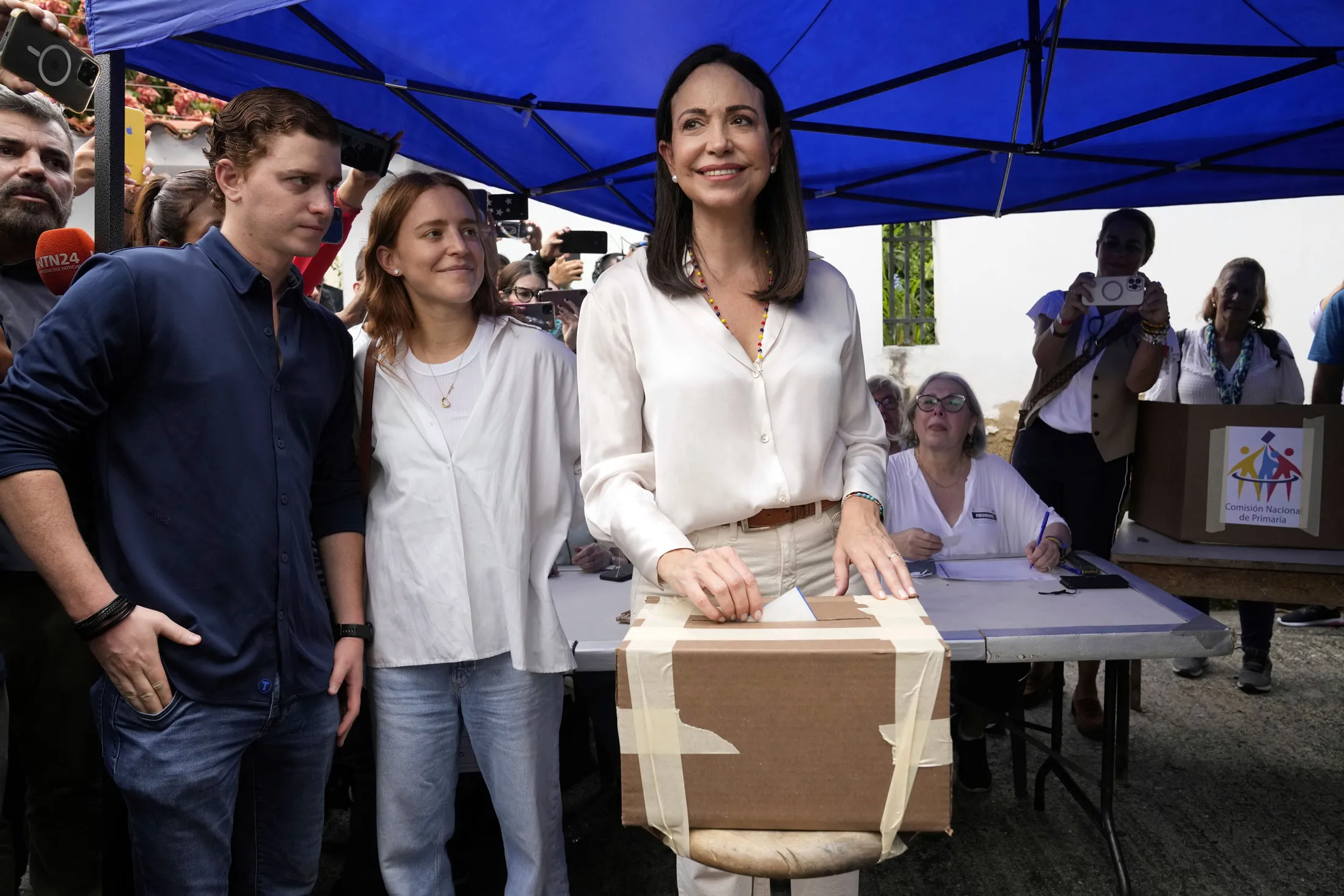 Machado casts her primary election ballot, with her children by her side, in Caracas on Oct. 22.