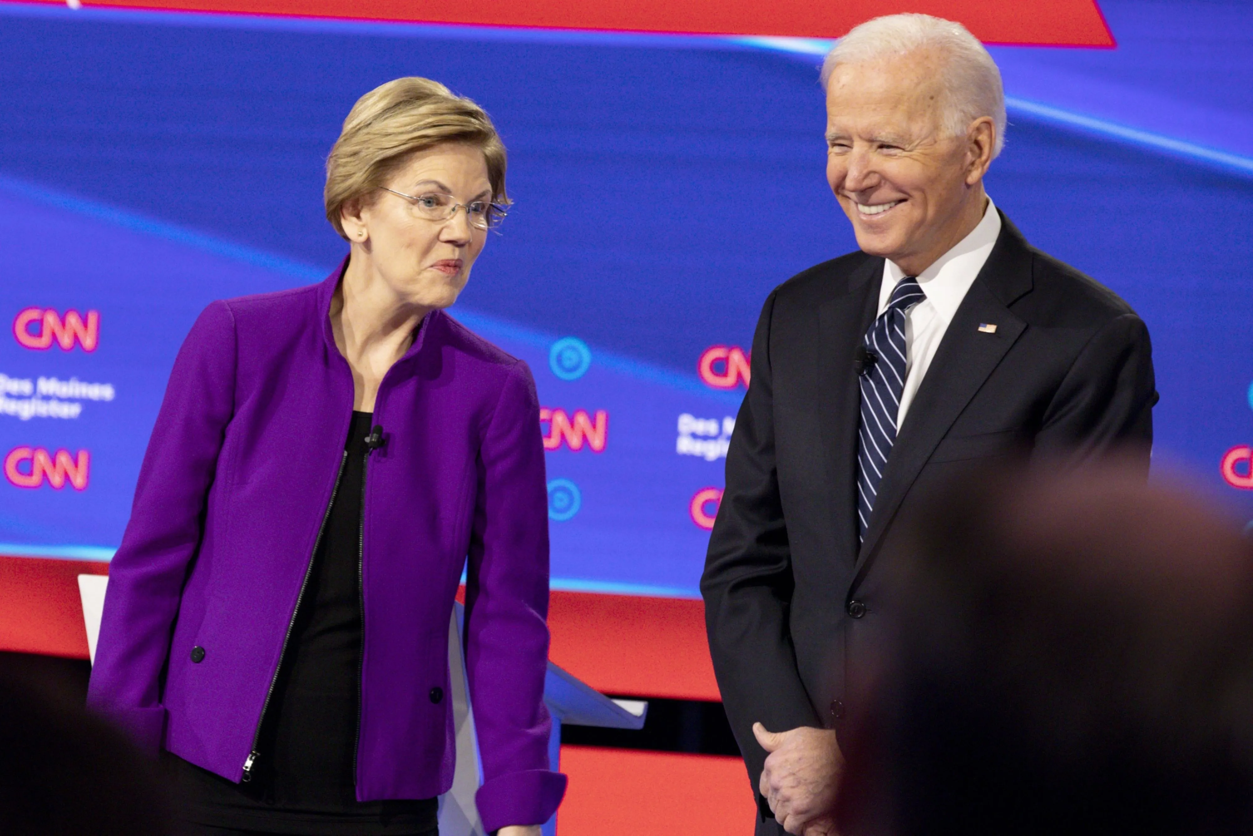 2020 Democratic presidential candidates Senator Elizabeth Warren, a Democrat from Massachusetts, left, and Former U.S. Vice President Joe Biden stand on stage ahead of the Democratic presidential debate in Des Moines, Iowa, on Tuesday, Jan. 14, 2020.