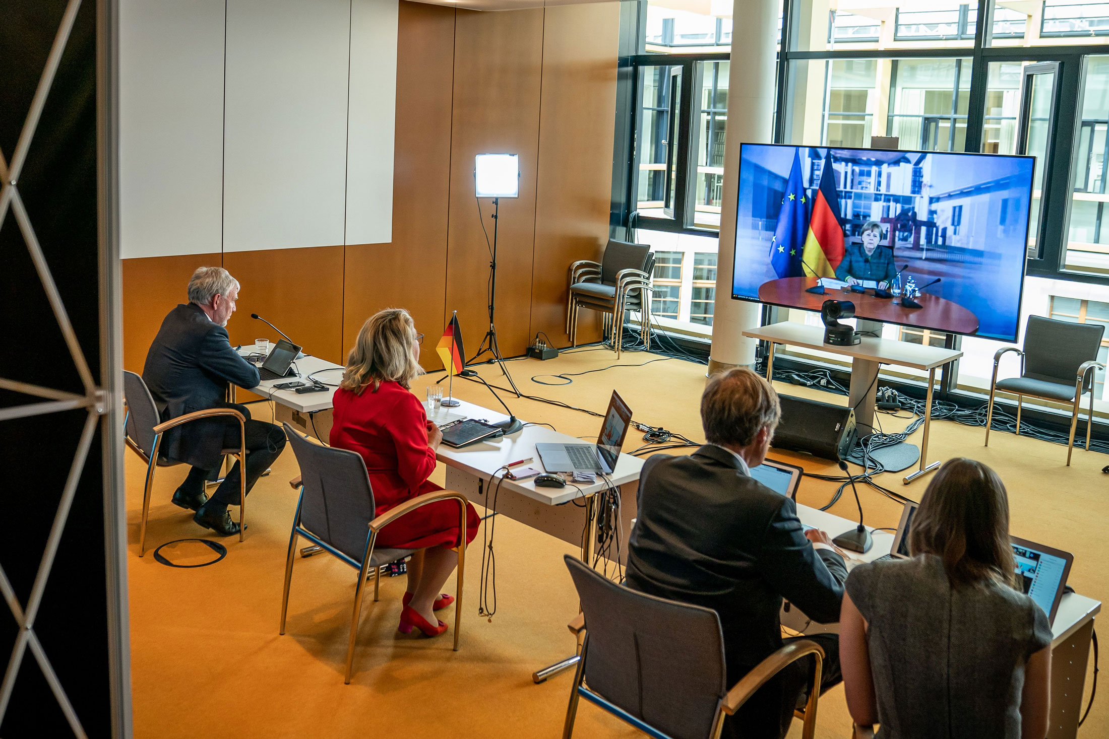 German Chancellor Angela Merkel is seen on a screen&nbsp;during a video conference of the Petersberg Climate Dialogue in Berlin on April 28, 2020.