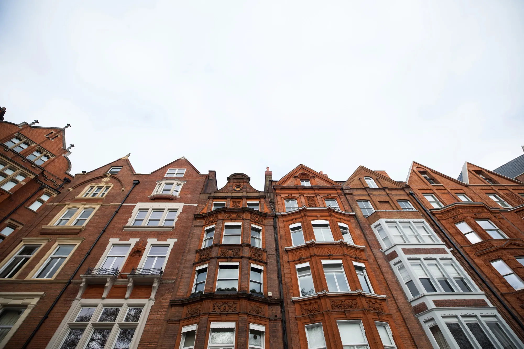 Red brick residential properties stand in the Kensington and Chelsea borough of London.