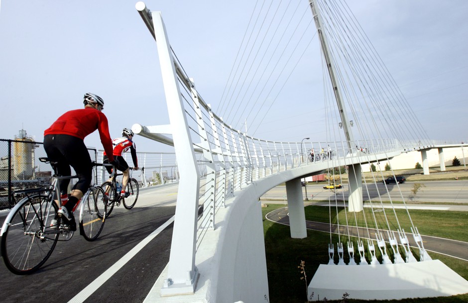A cable-stayed bridge in Minneapolis allows bikers to avoid traffic on Hiawatha Avenue, right. 