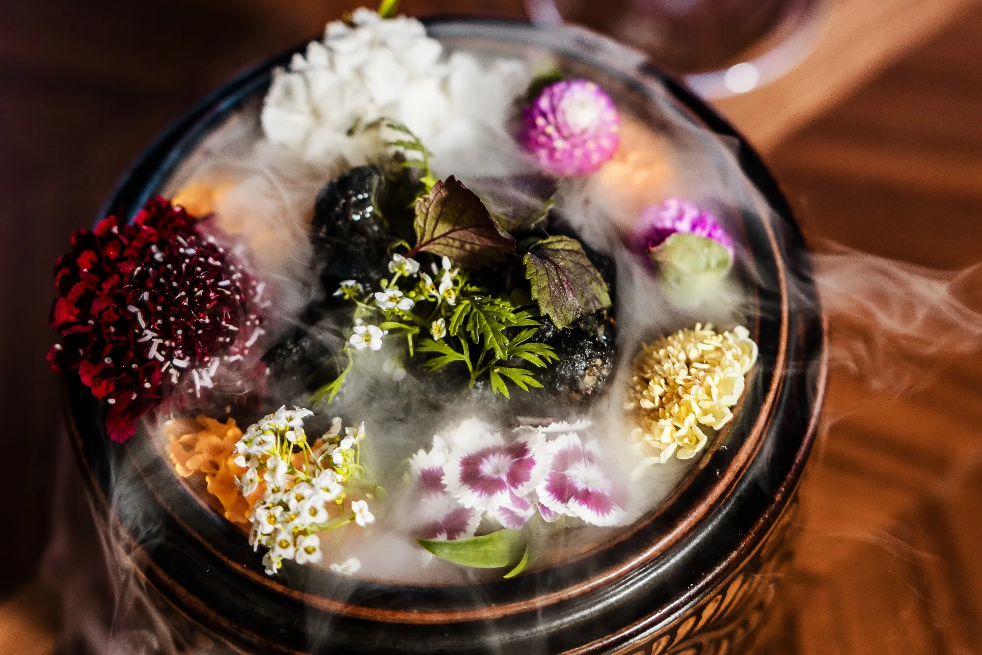 Cooked cells of cultivated chicken cutlets served with dry ice smoke at Bar Crenn in 2023.