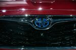A Toyota Motor Corp. badge is displayed on the front grille of a Highlander sports utility vehicle (SUV) .