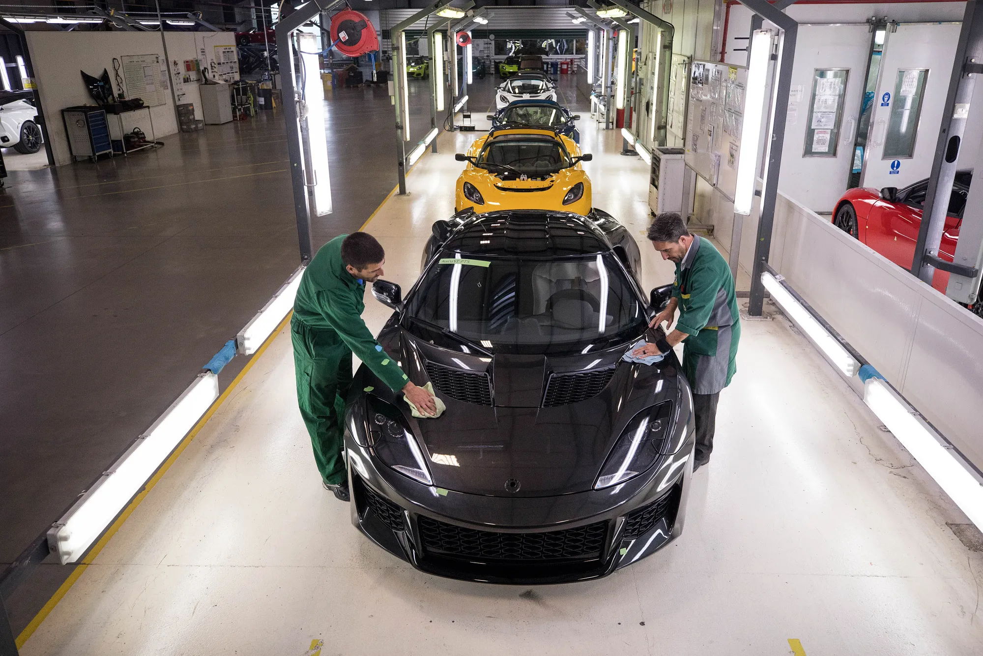 Employees polish an Lotus Evora sports car as it moves down the inspection line at the Lotus factory in Hethel, near Norwich, U.K.