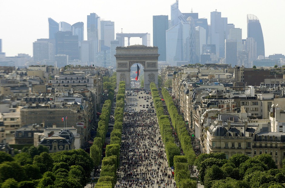 Pedestrians walk along the Champs Élysées during a car-free day.