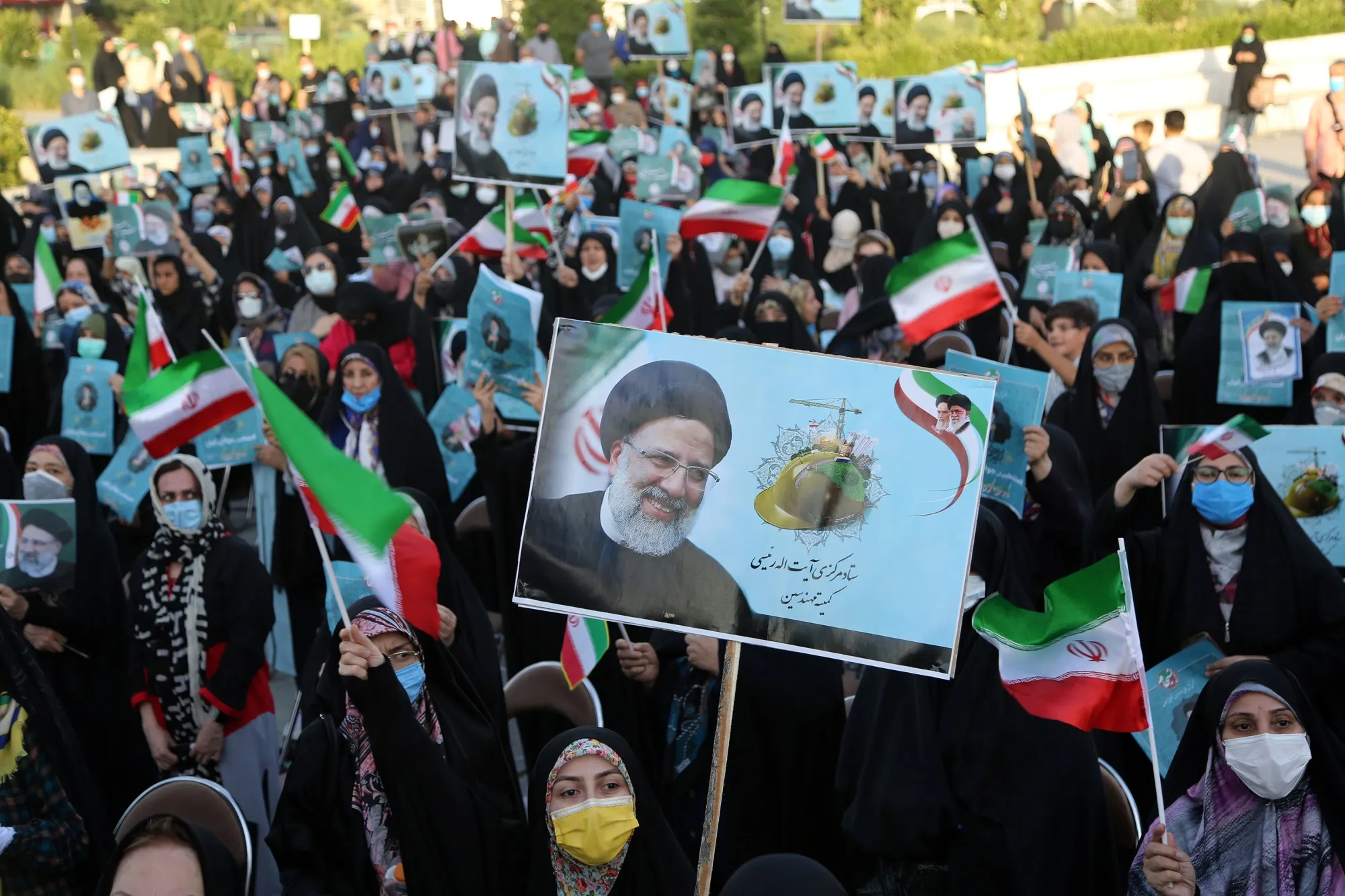 Supporters of presidential candidate Ebrahim Raisi gather during a rally in Tehran, on June 14.
