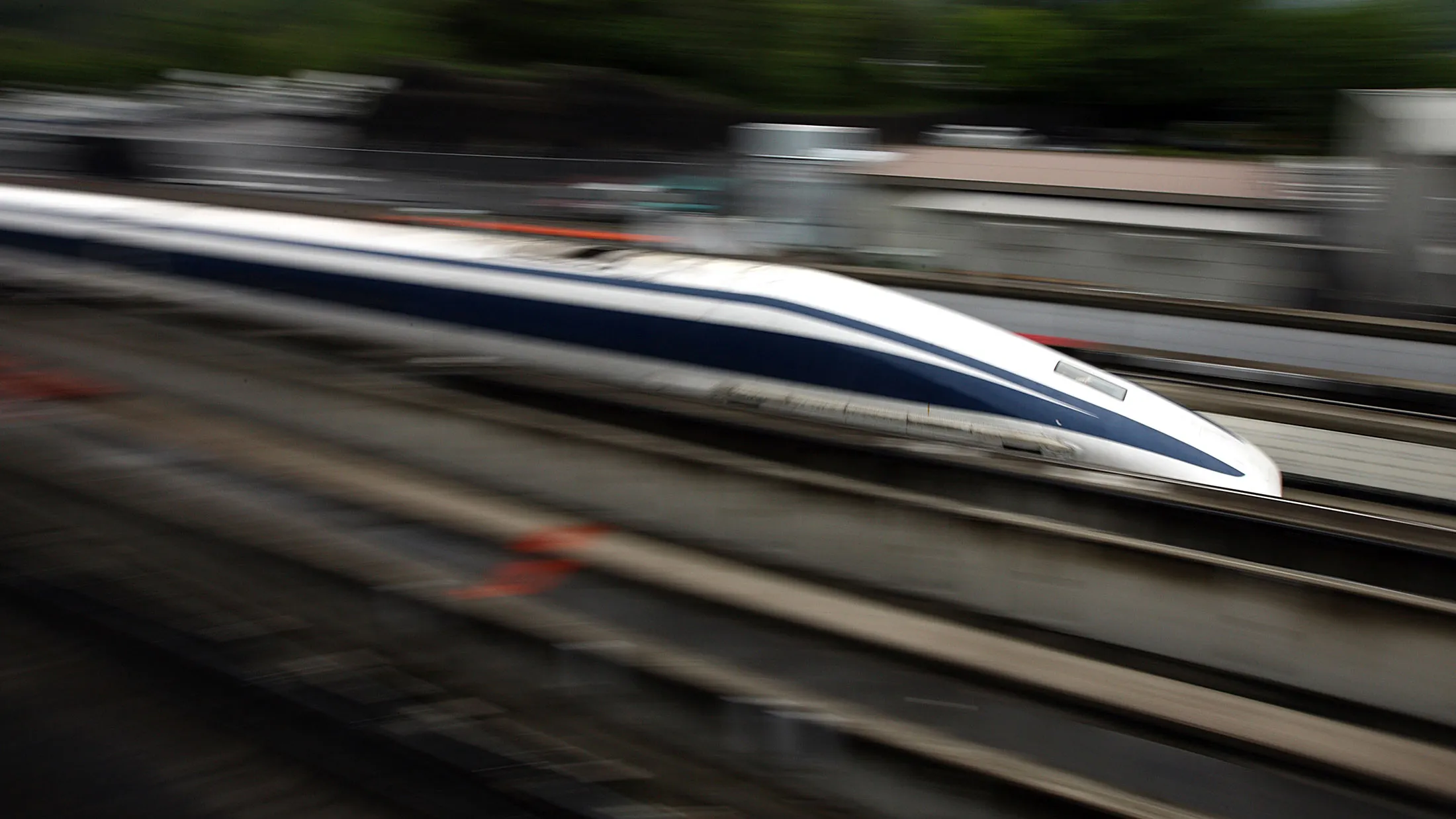 A magnetic-levitation (maglev) train passes at Central Japan Railway Co.'s Yamanashi Maglev test line, in Tsuru City, Yamanashi Prefecture, Japan.
