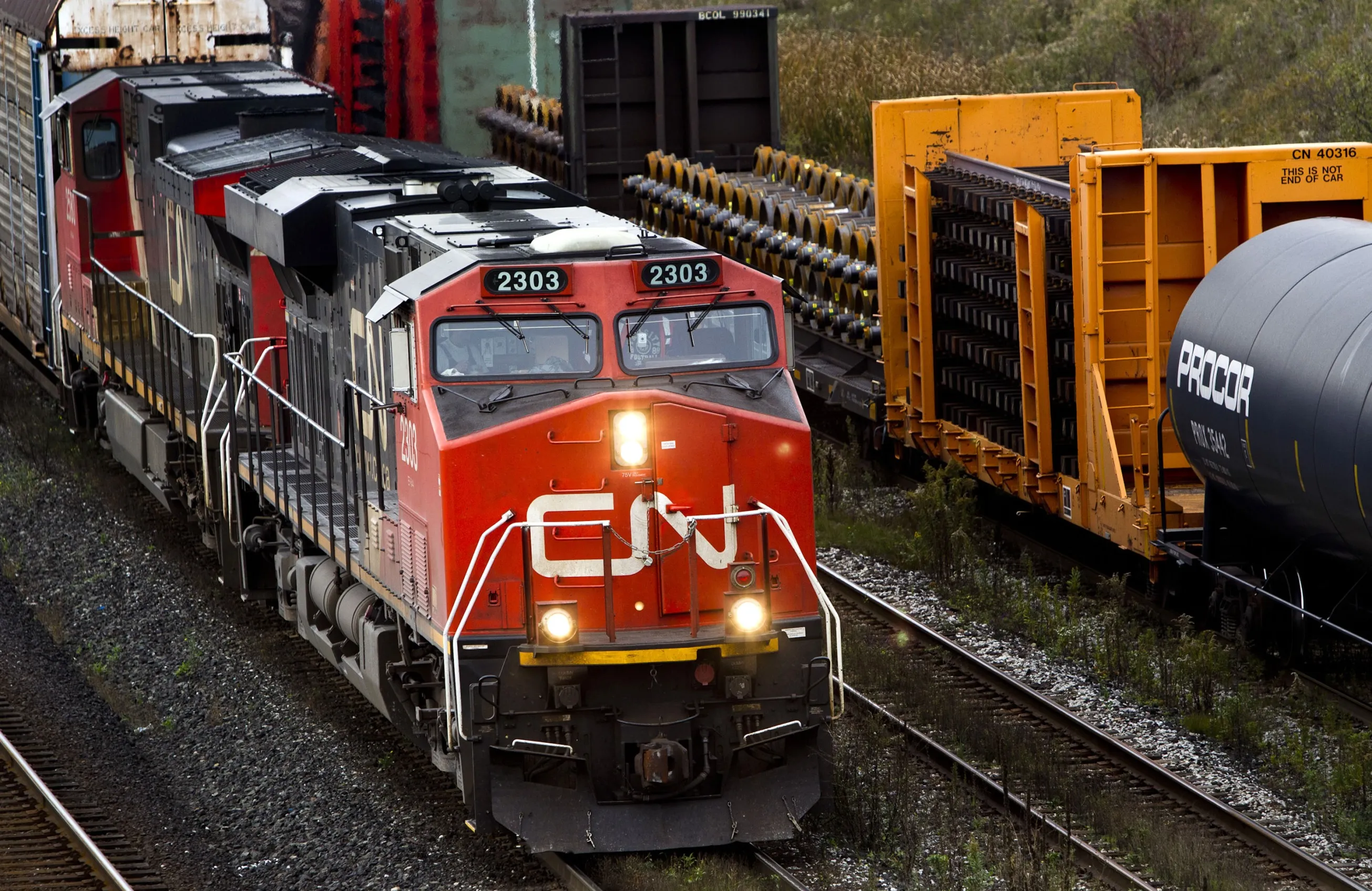 Canadian National Railway Co. (CN) trains pass through the Macmillan Yard in Toronto, Ontario, Canada, on Tuesday, Oct. 18, 2011. CN, the largest railway in Canada, is the country's only transcontinental railway company, spanning from the Atlantic coast in Nova Scotia to the Pacific coast in British Columbia.