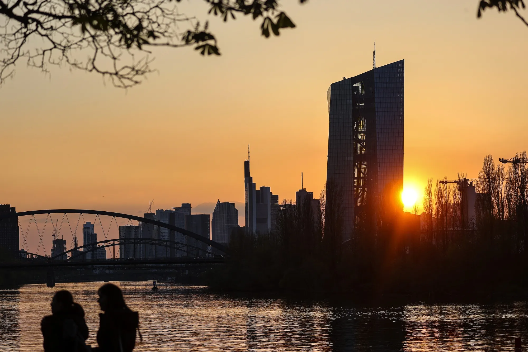 The European Central Bank (ECB) headquarters, right, and skyscrapers near the River Rhine at sunset in the financial district in Frankfurt, Germany, on Tuesday, April 20, 2021.