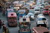 Commuters hang from the back of a jeepney traveling along a road in Manila, the Philippines, on Saturday, April 8, 2017. Smoke-belching jeepneys are as iconic to Manila as the cable cars of San Francisco, the gondolas on Venice's canals and the black cabs in London. The most popular public transport in the Philippines is now being targeted for the scrap heap as President Rodrigo Duterte tries to modernize the nation and clean up its air.