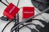 Two Wirecard AG branded red cubes rest between computer cables in this arranged photograph at the Wirecard headquarters in Munich, Germany, on Wednesday, Sept. 5, 2018. Commerzbank AG, part of the DAX Index stock gauge since its inception in 1988, will be replaced by fintech company Wirecard AG, index provider Deutsche Boerse AG said in a statement late on Wednesday.