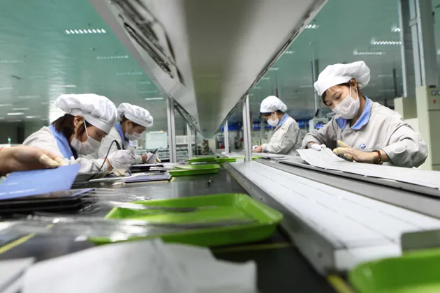 Employees work on a solar panel production line at Shenzhou New Energy Co., Ltd in Lianyungang, China