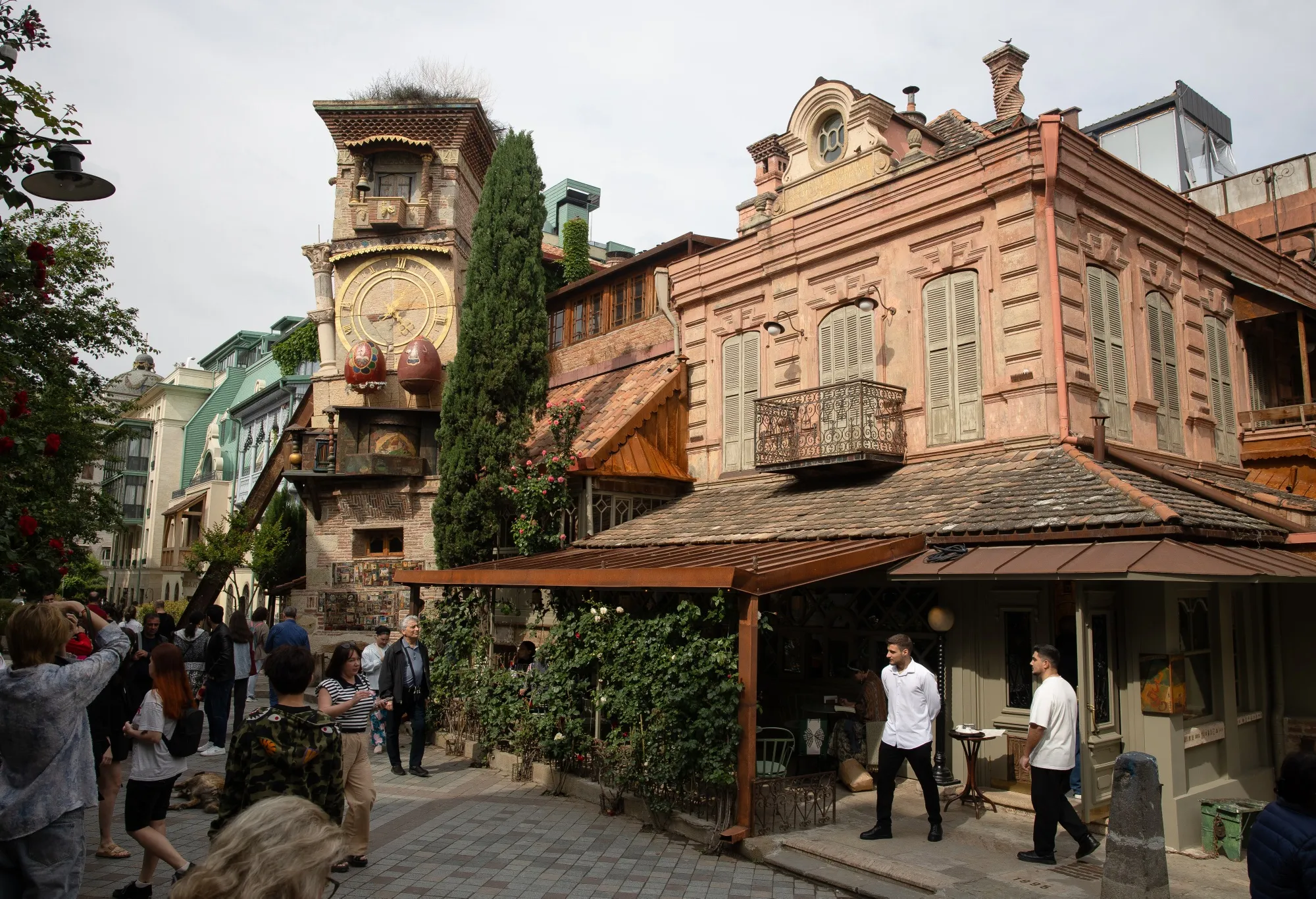Restaurant waiters wait for customers near the clock tower in the old town district of Tbilisi, Georgia, in May.&nbsp;