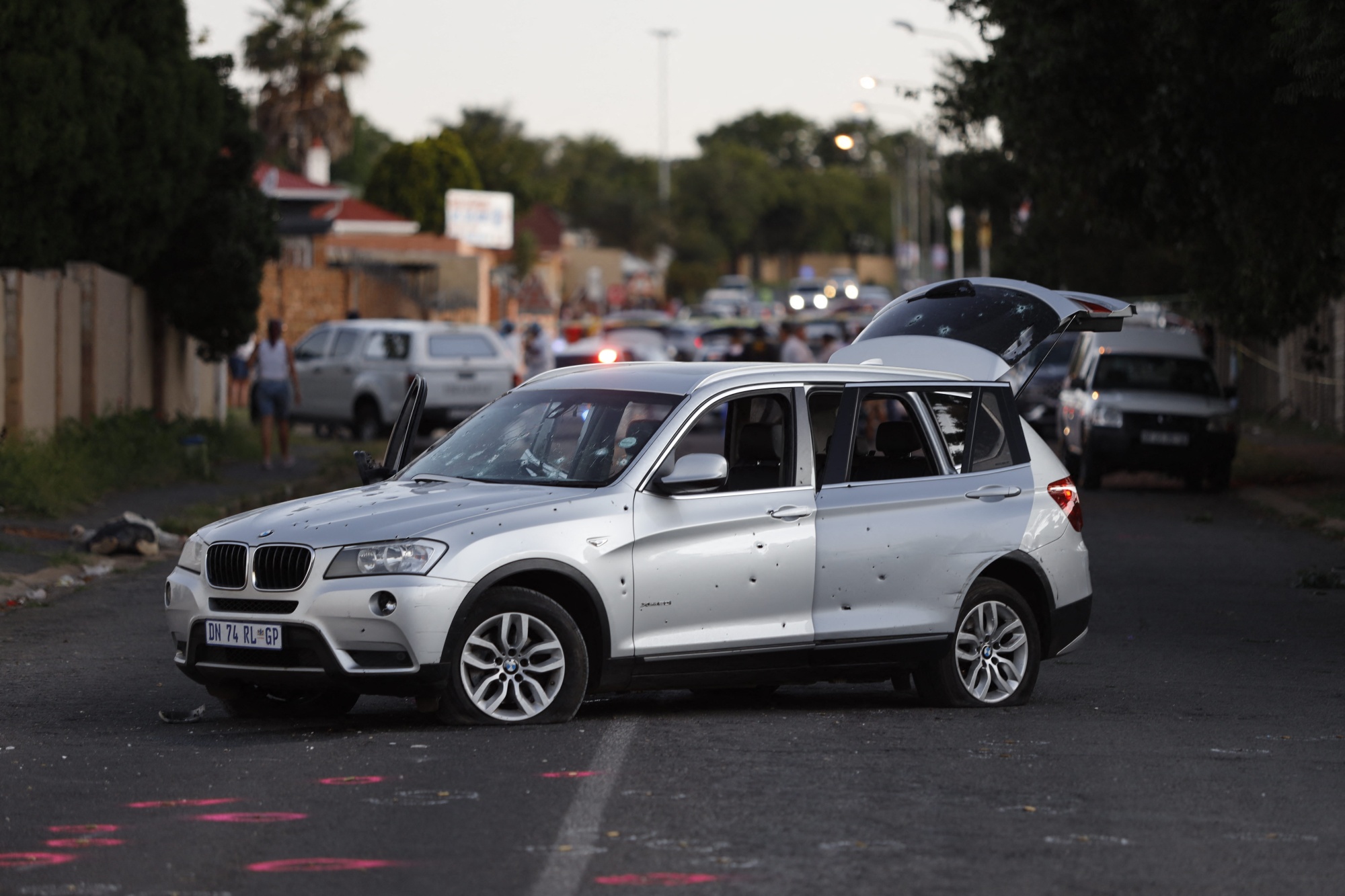 TOPSHOT - A bullet riddled vehicle is stationed in the middle of the street, part of the crime scene after a botched cash-in-transit attack in Rosettenville, on the outskirts of Johannesburg on February 21, 2022, resulting in two South African police officers being airlifted with chest wounds. - South Africa's already alarming number of murders and rapes kept increasing at the end of 2021, the police minister announced February 18, 2022. From October to December, the country suffered an average of 74 murders and 122 reported rapes every day, Police Minister Bheki Cele told a news conference. (Photo by GUILLEM SARTORIO / AFP) (Photo by GUILLEM SARTORIO/AFP via Getty Images) Photographer: GUILLEM SARTORIO/AFP