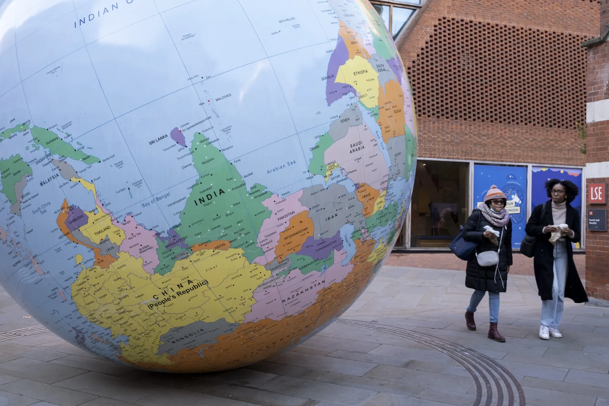 People's Republic of China and India are seen upside down on the public art sculpture The World Turned Upside Down by artist Mark Wallinger in London, 2022.